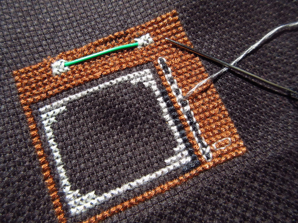 Partly done cross stitch of an old TV